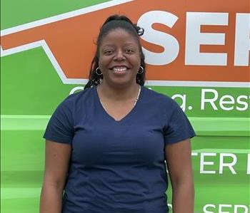 SERVPRO team member standing in front of a SERVPRO vehicle